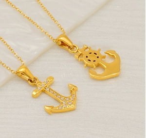 Detail of 18K gold plated anchor pendants with sparkling cubic zirconia on fine chains