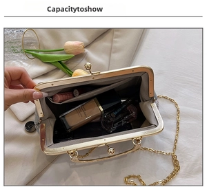 Detail view of the interior capacity of a floral chain bag with makeup essentials