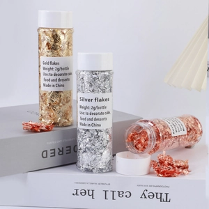 Detailed view of gold, silver, and rose gold decorative flakes in 2g clear jars