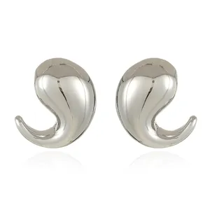 Macro detail of geometric teardrop earrings with high-polish silver mirror finish