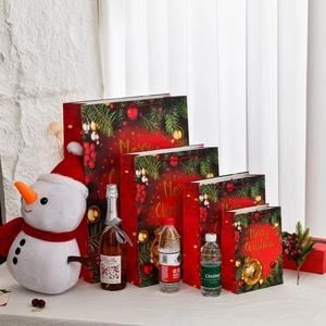 Extra large Christmas gift bags with gold foil lettering and red ribbon handles