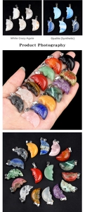 Macro detail of carved gemstone moon face pendants in multiple natural stone colors
