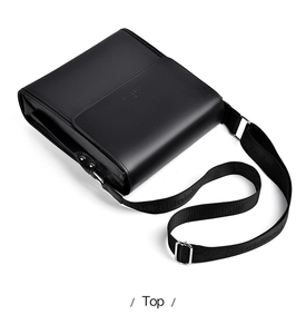 Detail view of black PU leather shoulder bag with magnetic flap and lettered strap