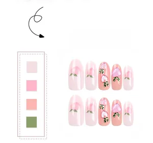 Detail of peach design press-on nails with 3D heart rhinestones and pink gradient finish