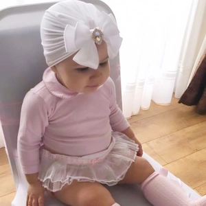 Infant girl set with white oversized bow turban hat, pink top and tulle skirt outfit