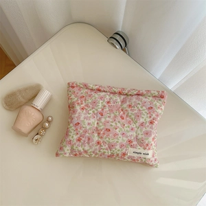 Detailed view of pink floral quilted cotton pouch with delicate embroidery and soft padding