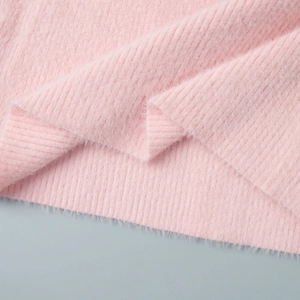 Macro detail of soft pink plush knit fabric with thick vertical ribbed texture