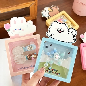 Close-up of cute cartoon jewelry boxes in pink and blue with transparent display windows