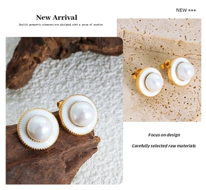Macro detail of French vintage gold earrings featuring white pearls in textured settings