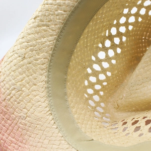 Detail of hand-woven straw hat showing gradient dye, sweatband and breathable mesh