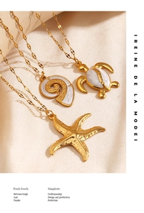 Detailed close-up of gold marine necklaces featuring turtle shell and starfish pendants
