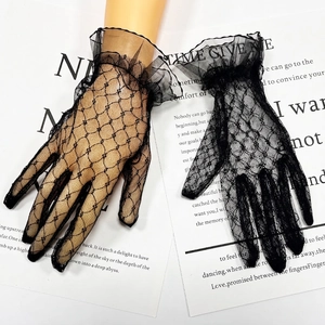 Detail of black lace gloves featuring floral mesh pattern and double layered ruffled wrists