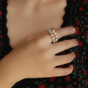 Double-layer pearl ring with zircon flower accents shown on finger for an elegant look