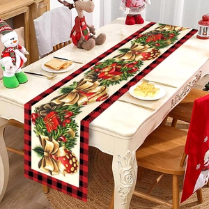 Close-up of Christmas table runner with festive bell patterns and red plaid edges