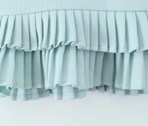 Macro detail of mint green pleated fabric with double-layered honeycomb knit texture