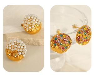 Macro detail of vintage gold disc earrings with white pearl and colorful rhinestones