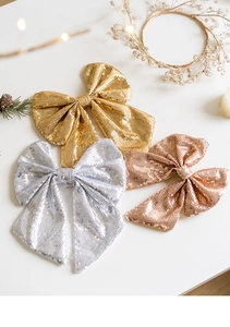 Glittering gold, silver, and rose gold Christmas bows with sequins for DIY tree decoration