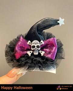 Detail of Halloween mini wizard hat clip with purple glitter bow and skull charm