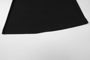 Close-up of the double-needle stitching and fabric texture on the black dress hemline
