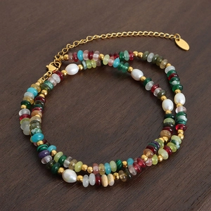 Bohemian double-layer necklace with freshwater pearls and colorful stones on wood