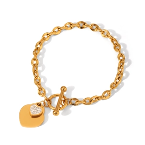 Detail of gold heart charms with pavé crystals and toggle clasp on chunky chain