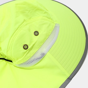 Detail of high-visibility neon yellow hat with breathable mesh and reflective trim