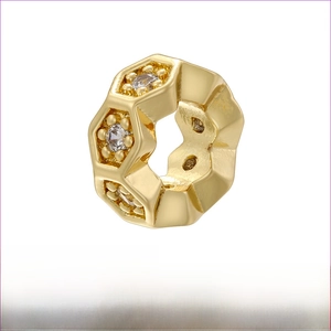 Macro view of gold plated honeycomb bead with white zircon inlays for jewelry DIY
