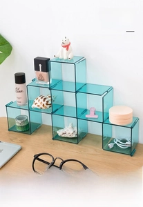 Modular blue acrylic storage drawers for cosmetics shown in a desktop organizer setup