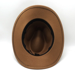 Detail view of the brown felt cowboy hat interior featuring a size 57 label and sweatband