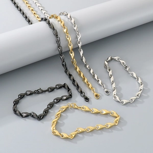 Detailed view of hip-hop twisted chain links in black, gold, and silver finishes