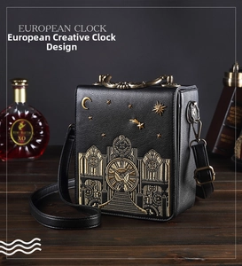 Detailed close-up of retro black leather clock bag with gold embroidery and metal handle
