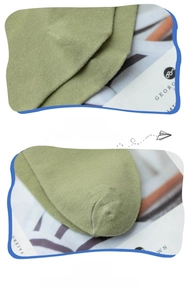Close-up of grass green cotton socks showing reinforced heel and seamless toe details