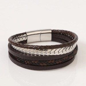 Detail view of multilayer brown braided leather bracelet with silver metal chain and magnetic clasp