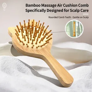 Cat-shaped bamboo scalp massage cushion brush on soft white fabric for daily hair care