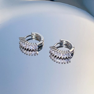 Close-up of silver-tone hoop earrings with densely set clear cubic zirconia stones