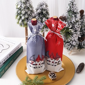 Christmas gnome wine bottle covers in red and grey colors for festive table decor