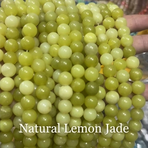 Close-up of natural lemon jade round beads with smooth translucent texture for DIY jewelry