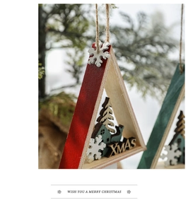 Detail of red and green wooden Christmas tree ornaments with XMAS laser cut lettering