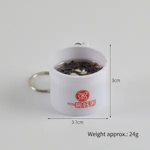 Miniature black rice porridge food keychain with 3cm height and white bowl detail