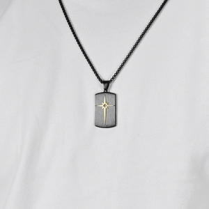 Men's black stainless steel rectangle necklace with golden starburst pendant on woven chain