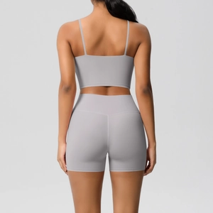 Detail of light grey yoga set back design featuring slim straps and high waist shorts