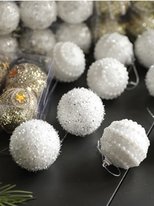 Detailed view of white and gold Christmas balls with sequins, beads and glitter textures