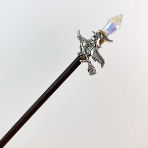 Detail of a wizard on broomstick hair pin with iridescent faceted crystal stone