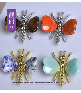 Detail of stone butterfly figurines in tiger eye and jasper with gold and silver plating