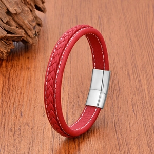 Detail of red braided leather bracelet with white stitching and silver magnetic clasp