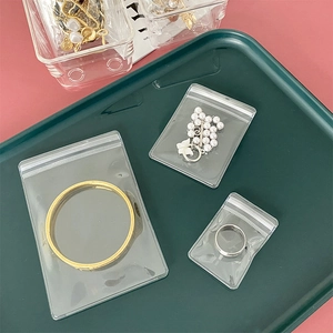 Transparent PVC jewelry storage bags in various sizes with bracelets and rings