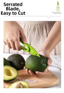 Close-up of serrated blade on 3-in-1 avocado slicer tool cutting fresh green fruit
