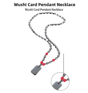 Detailed view of faceted hematite beads with red accents and a rectangular pendant