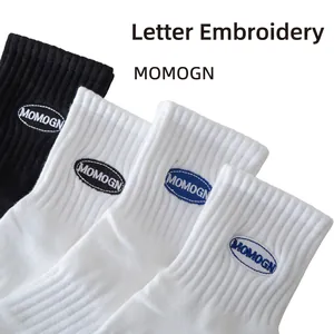 Mid-cut cotton sport socks in black and white featuring MOMOGN letter embroidery detail