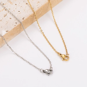 Niche stainless steel hollow cross necklace shown in gold and silver with lobster clasp
